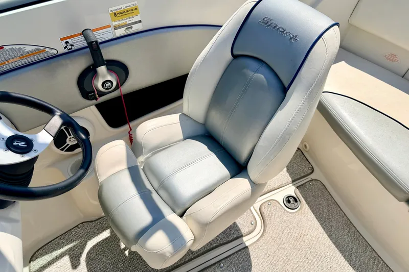 Slide: The Image of 2008 Sea Ray 195 Sport boat interior with steering wheel and cushioned seat. - 47