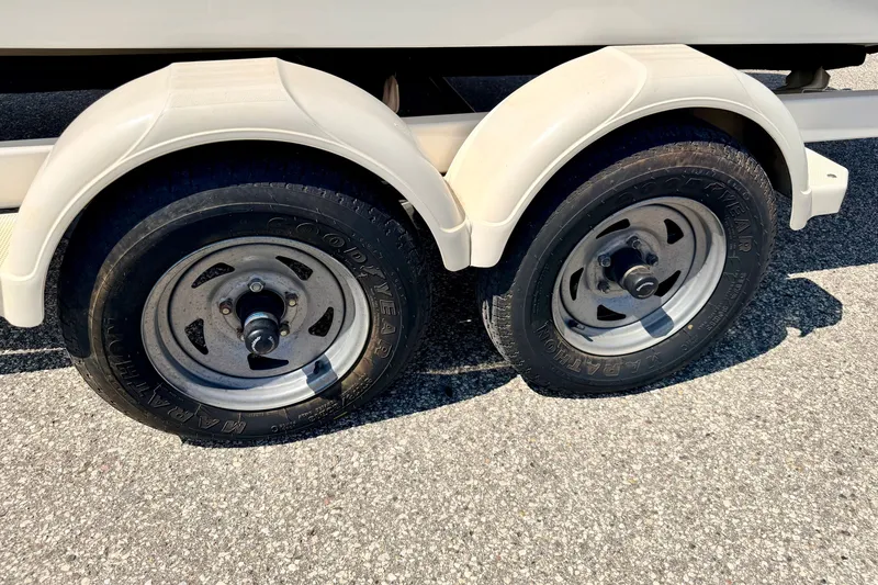Slide: The Image of Trailer wheels of a 2008 Sea Ray 195 Sport boat on asphalt. - 73