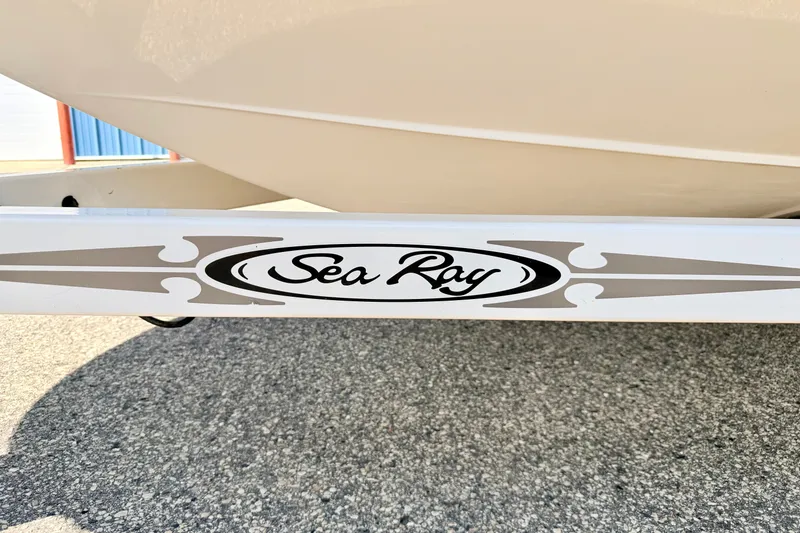 Slide: The Image of Sea Ray 195 Sport 2008 boat trailer with logo on pavement background. - 70