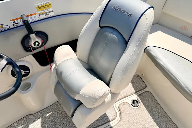 Slide: The Image of 2008 Sea Ray 195 Sport boat interior with steering wheel and cushioned seat. - 48