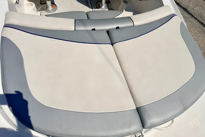 Slide: The Image of 2008 Sea Ray 195 Sport boat seating, featuring gray and white upholstery. - 25