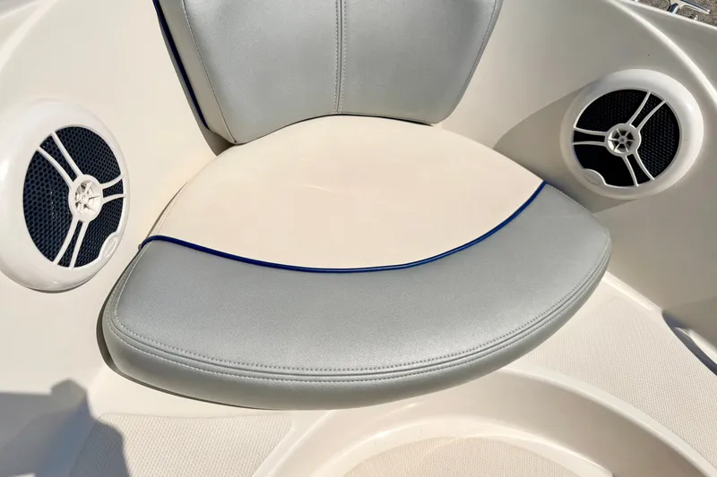 Slide: The Image of 2008 Sea Ray 195 Sport boat interior with cushioned seating and built-in speakers. - 56