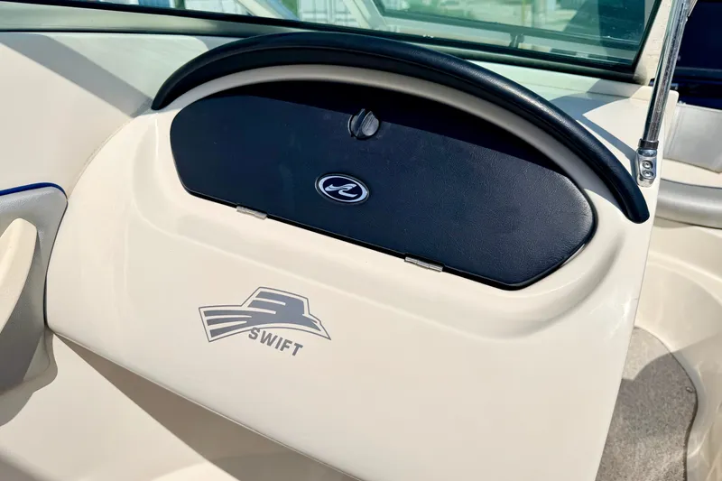Slide: The Image of 2008 Sea Ray 195 Sport boat dashboard with Swift logo and black compartment. - 51