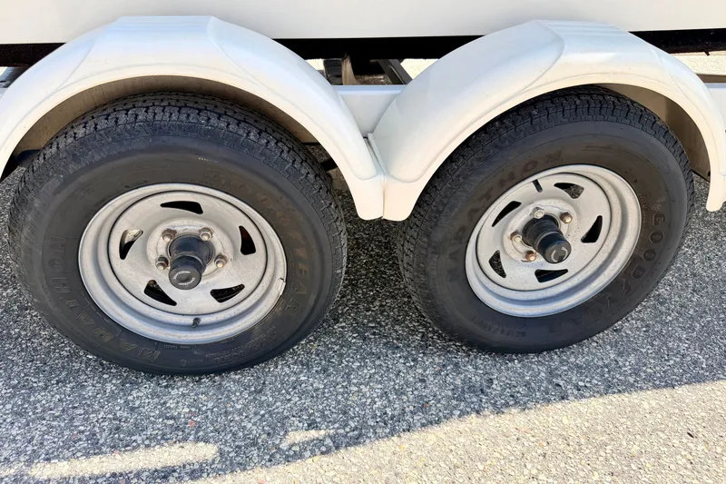 Slide: The Image of Dual trailer wheels for 2008 Sea Ray 195 Sport boat on asphalt. - 76