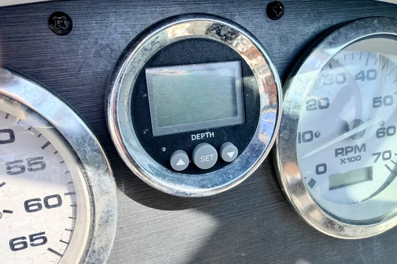 Slide: The Image of Close-up of 2008 Sea Ray 195 Sport boat dashboard gauges, including depth and RPM indicators. - 46