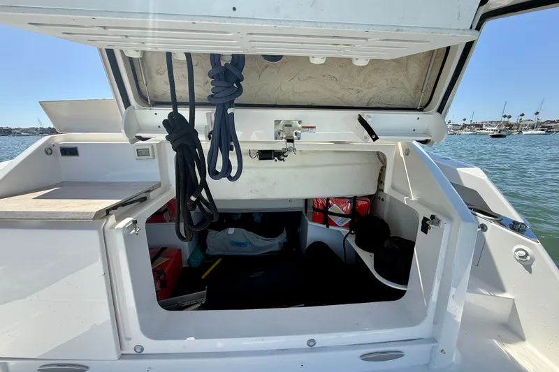 Slide: The Image of Open storage compartment on a 2015 Tiara Yachts 50 Coupe, with ropes and equipment visible. - 88