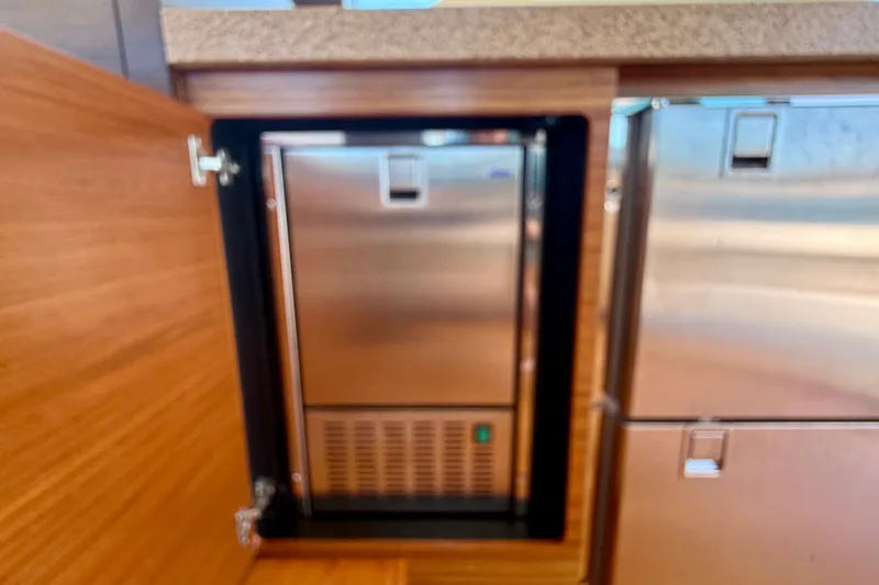 Slide: The Image of Built-in stainless steel refrigerator on 2015 Tiara Yachts 50 Coupe. - 35
