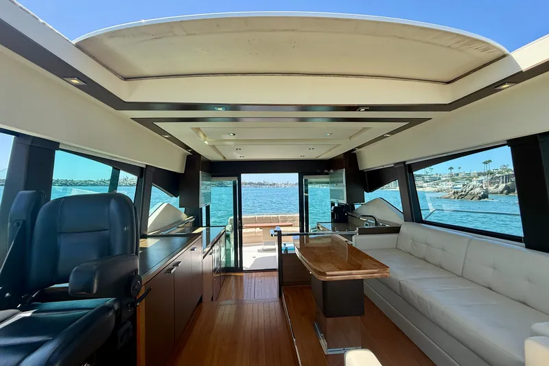 Slide: The Image of Interior of 2015 Tiara Yachts 50 Coupe with luxurious seating and ocean view. - 38