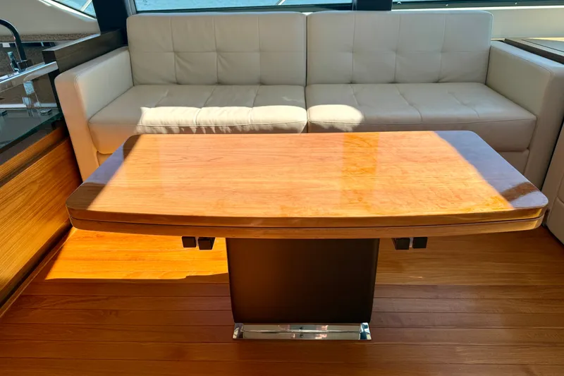 Slide: The Image of Luxurious interior of 2015 Tiara Yachts 50 Coupe with elegant wood table and white sofa. - 18