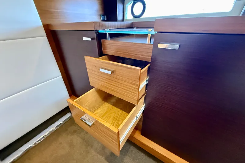 Slide: The Image of Wooden drawers in a 2015 Tiara Yachts 50 Coupe interior, showcasing elegant storage design. - 51