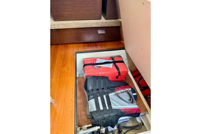 Slide: The Image of Storage compartment in 2015 Tiara Yachts 50 Coupe with life jackets and equipment. - 46