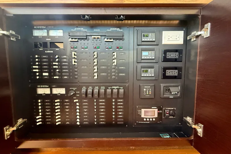 Slide: The Image of Electrical control panel of a 2015 Tiara Yachts 50 Coupe, featuring AC and DC systems. - 45