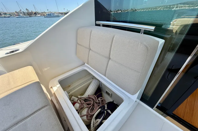 Slide: The Image of Storage compartment on 2015 Tiara Yachts 50 Coupe, featuring ropes and fenders. - 92