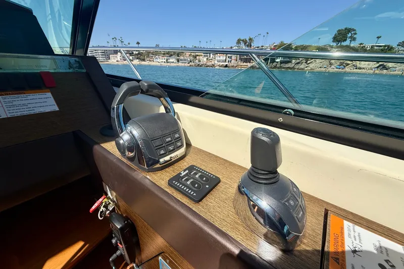 Slide: The Image of Helm controls of a 2015 Tiara Yachts 50 Coupe with ocean view. - 41
