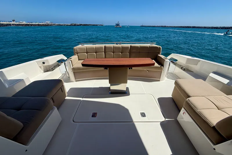 Slide: The Image of Luxurious seating area on 2015 Tiara Yachts 50 Coupe, overlooking serene ocean waters. - 75
