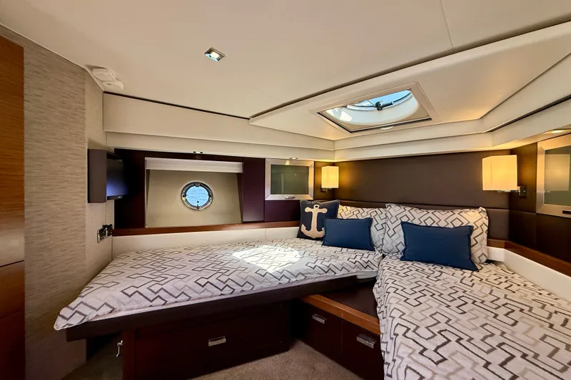 Slide: The Image of Luxurious cabin interior of 2015 Tiara Yachts 50 Coupe with elegant bedding and porthole view. - 62