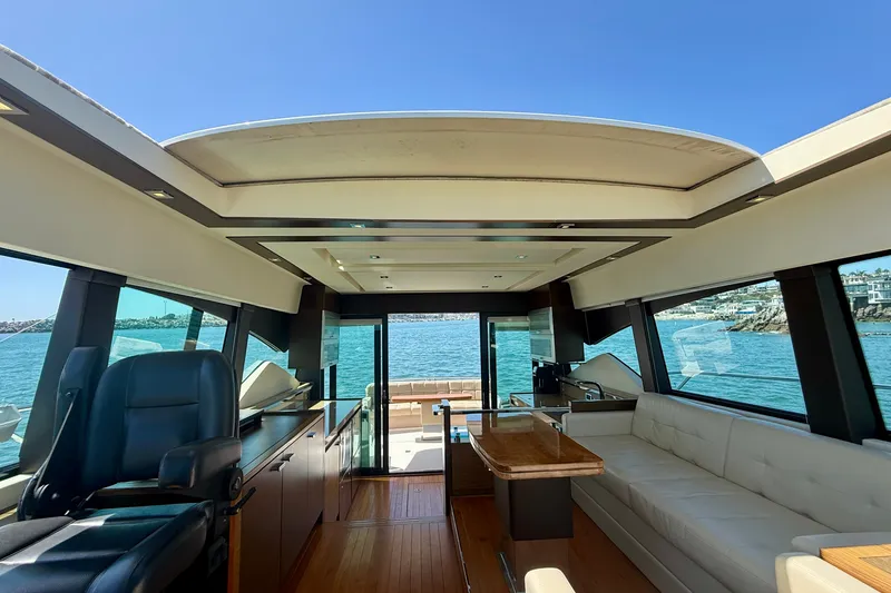 Slide: The Image of Interior of 2015 Tiara Yachts 50 Coupe with luxurious seating and ocean view. - 37