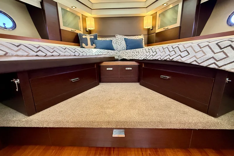 Slide: The Image of Luxurious interior of 2015 Tiara Yachts 50 Coupe with elegant bedding and storage. - 61