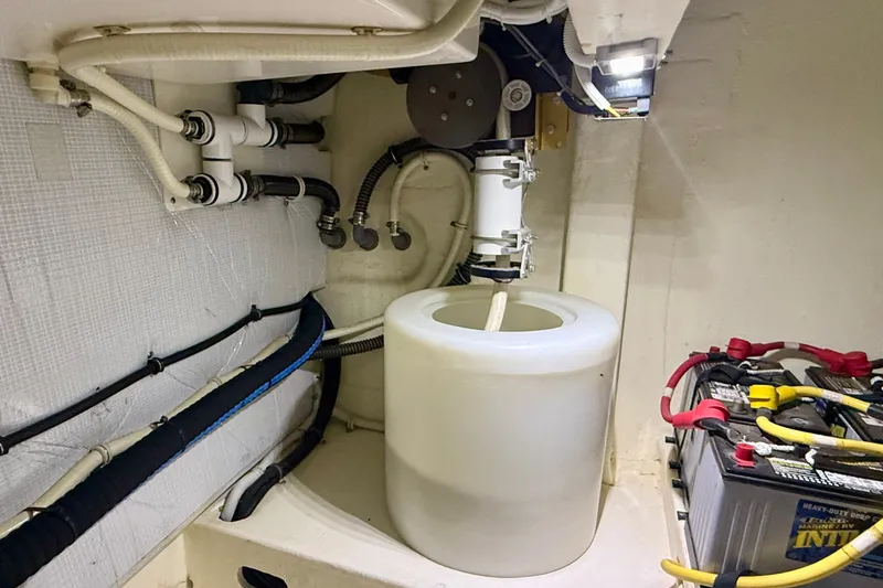 Slide: The Image of Engine room of 2015 Tiara Yachts 50 Coupe with battery and plumbing components. - 105