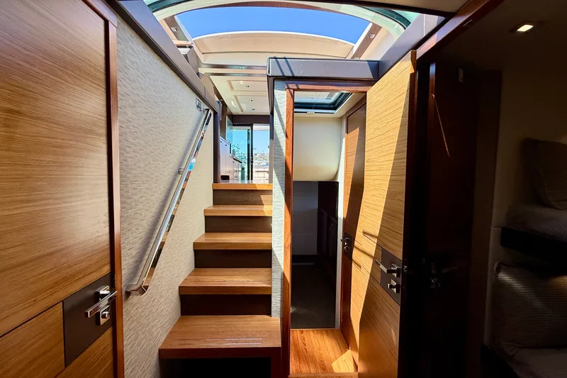 Slide: The Image of Interior view of 2015 Tiara Yachts 50 Coupe with wooden stairs and skylight. - 57