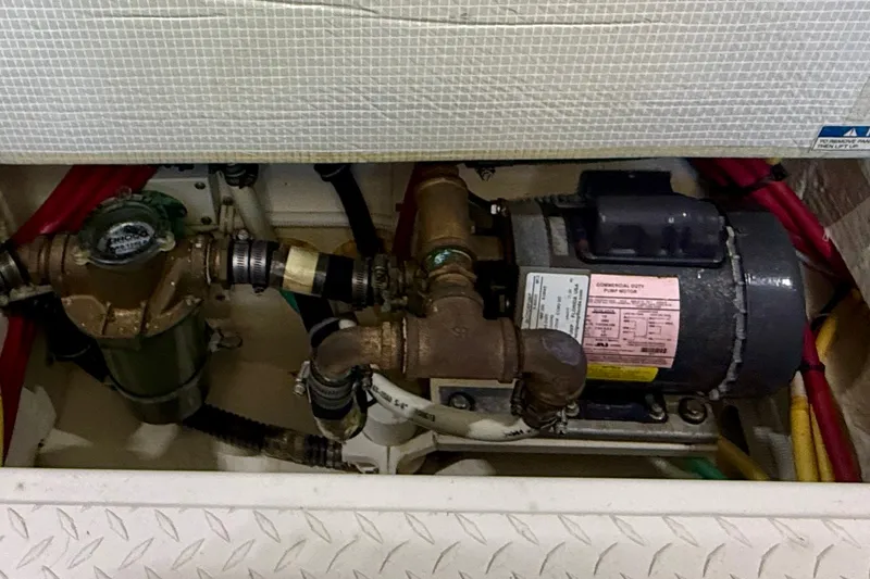 Slide: The Image of Engine compartment of a 2015 Tiara Yachts 50 Coupe, showing mechanical components and wiring. - 103