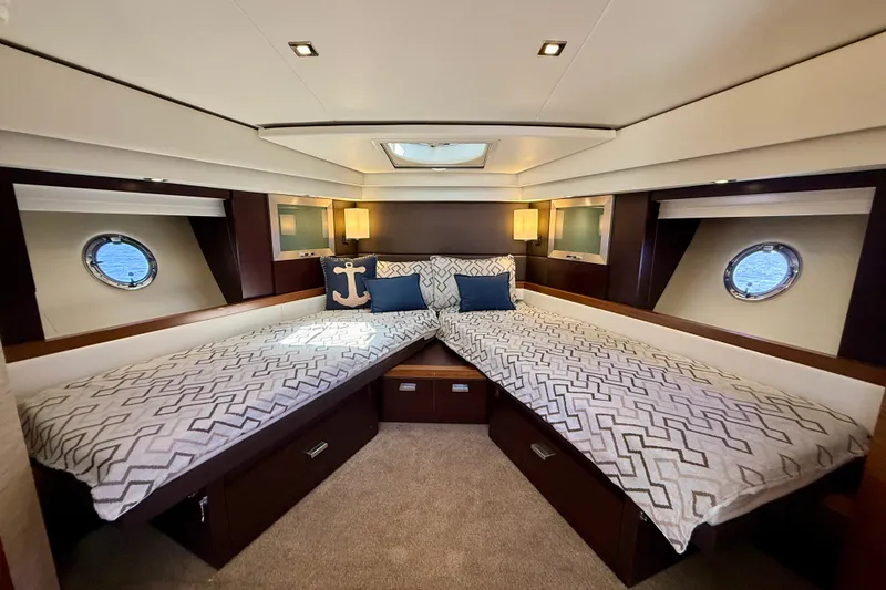 Slide: The Image of Luxurious 2015 Tiara Yachts 50 Coupe cabin with twin beds and nautical decor. - 60