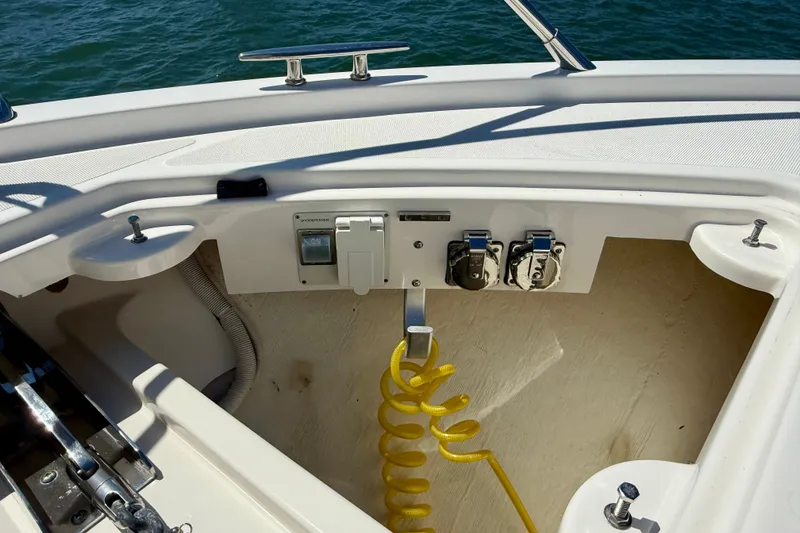 Slide: The Image of 2015 Tiara Yachts 50 Coupe deck with utility connections and coiled yellow hose. - 84