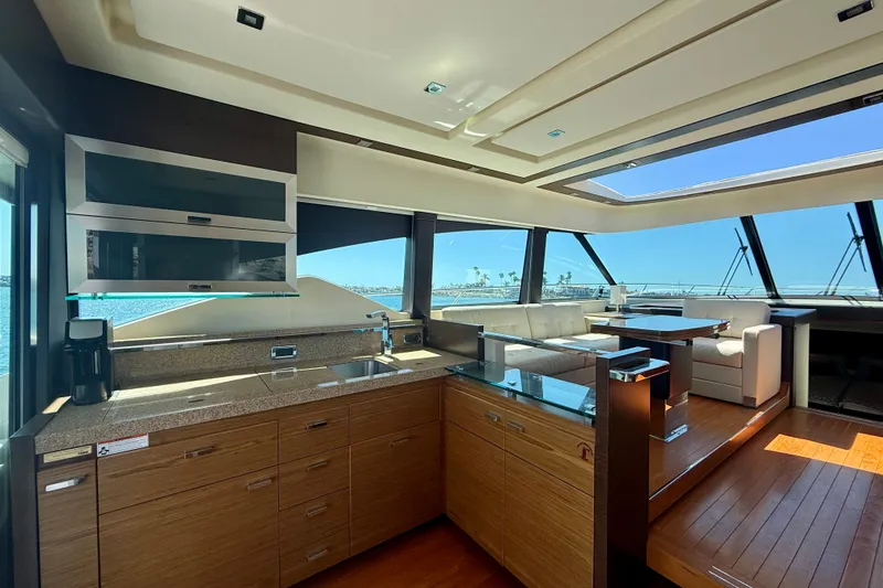 Slide: The Image of Luxurious interior of 2015 Tiara Yachts 50 Coupe with modern kitchen and seating area. - 19