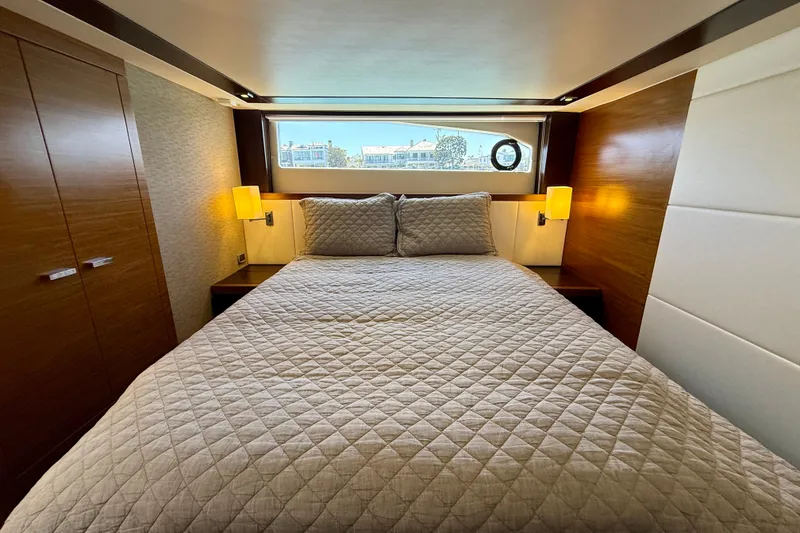 Slide: The Image of Luxurious bedroom interior of 2015 Tiara Yachts 50 Coupe with elegant bedding and wood accents. - 48
