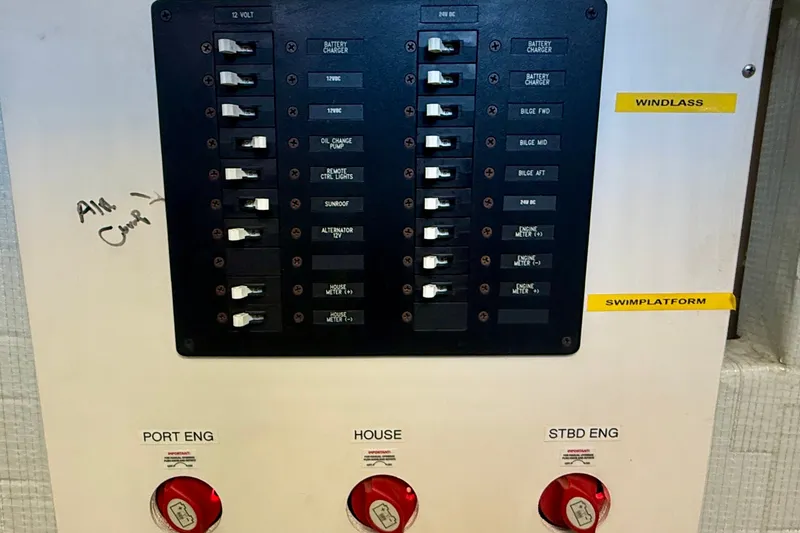 Slide: The Image of Electrical panel of a 2015 Tiara Yachts 50 Coupe, featuring switches and labeled controls. - 102