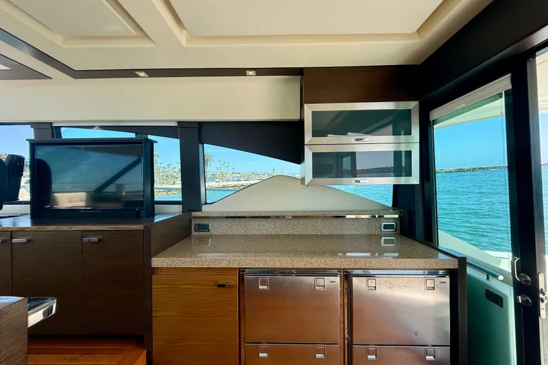 Slide: The Image of Interior of 2015 Tiara Yachts 50 Coupe with modern cabinetry and ocean view. - 25