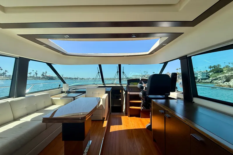 Slide: The Image of Luxurious interior of a 2015 Tiara Yachts 50 Coupe with panoramic windows and elegant furnishings. - 13