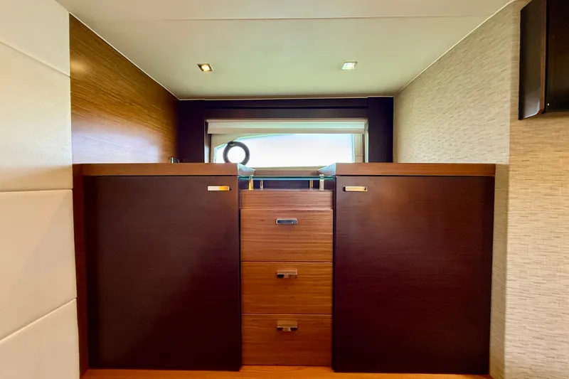 Slide: The Image of Interior of 2015 Tiara Yachts 50 Coupe featuring elegant wooden cabinetry. - 50