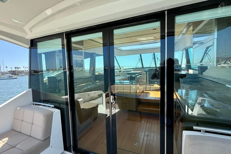 Slide: The Image of 2015 Tiara Yachts 50 Coupe interior view with glass doors and seating area. - 79