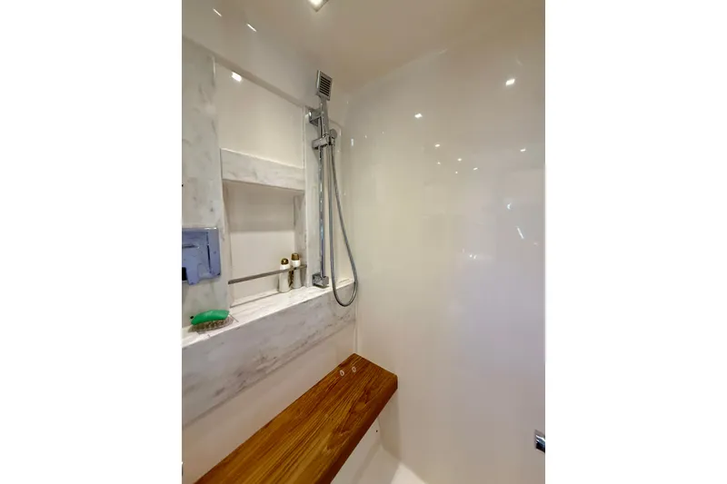 Slide: The Image of Luxurious shower area in 2015 Tiara Yachts 50 Coupe with wooden bench and modern fixtures. - 55