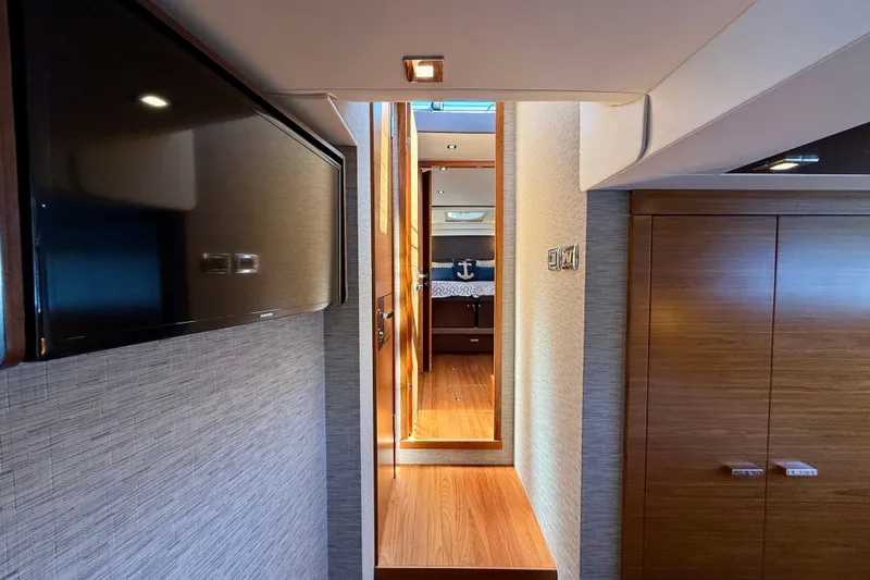 Slide: The Image of Interior hallway of 2015 Tiara Yachts 50 Coupe, featuring wood finishes and modern design. - 53