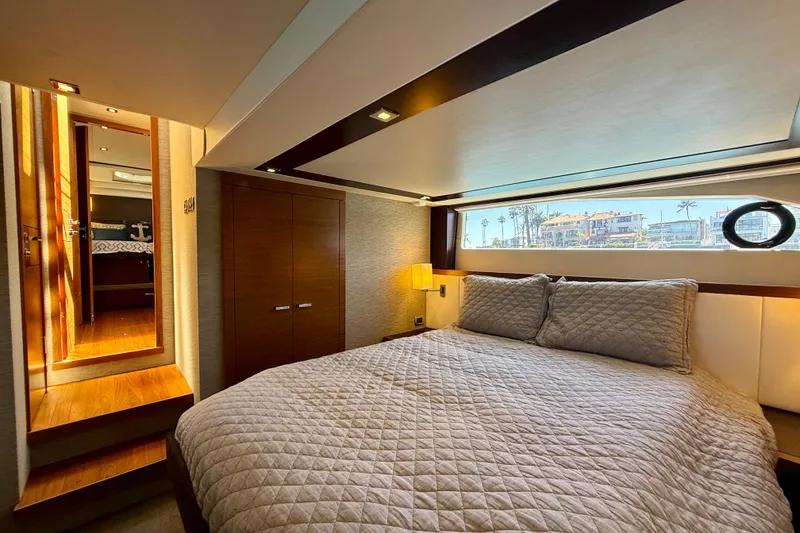 Slide: The Image of Luxurious bedroom interior of 2015 Tiara Yachts 50 Coupe with elegant bedding and scenic window view. - 49