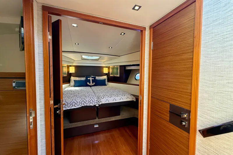 Slide: The Image of Luxurious bedroom interior of 2015 Tiara Yachts 50 Coupe with nautical decor. - 58