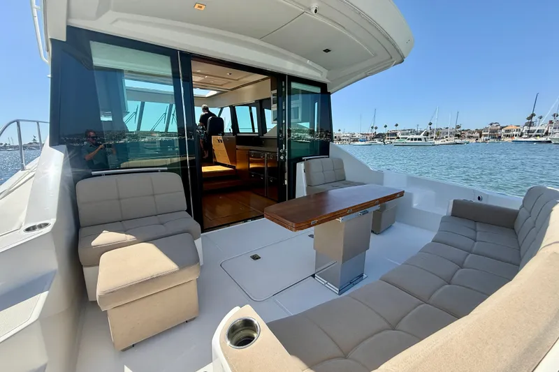 Slide: The Image of Luxurious 2015 Tiara Yachts 50 Coupe with spacious outdoor seating and scenic marina view. - 72