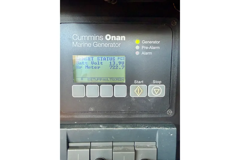 Slide: The Image of Cummins Onan marine generator display on 2015 Tiara Yachts 50 Coupe, showing battery voltage and hour meter. - 95