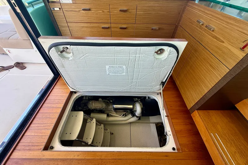 Slide: The Image of Engine compartment of a 2015 Tiara Yachts 50 Coupe, showcasing interior access. - 93
