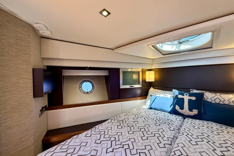 Slide: The Image of Luxurious 2015 Tiara Yachts 50 Coupe bedroom with nautical decor and elegant bedding. - 63