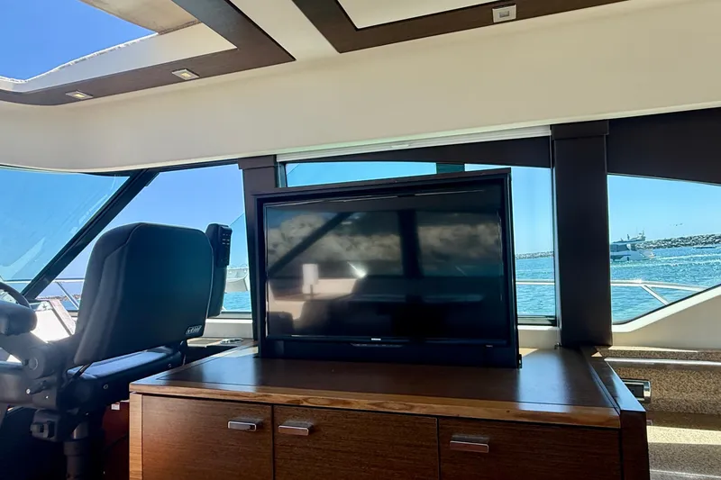 Slide: The Image of Interior of 2015 Tiara Yachts 50 Coupe with TV and ocean view. - 24