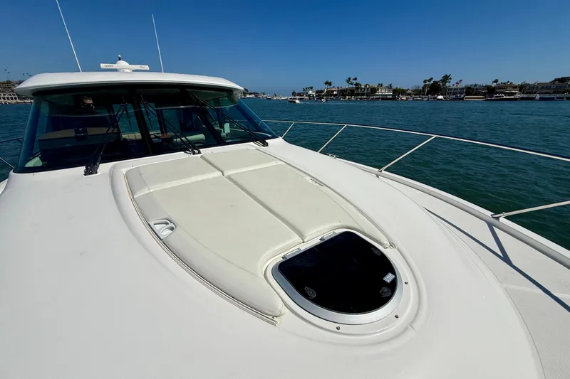 Slide: The Image of 2015 Tiara Yachts 50 Coupe on water, showcasing sleek deck design and ocean view. - 81