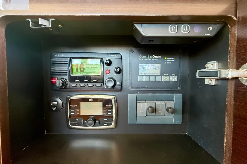 Slide: The Image of Control panel of a 2015 Tiara Yachts 50 Coupe featuring marine electronics and generator controls. - 44
