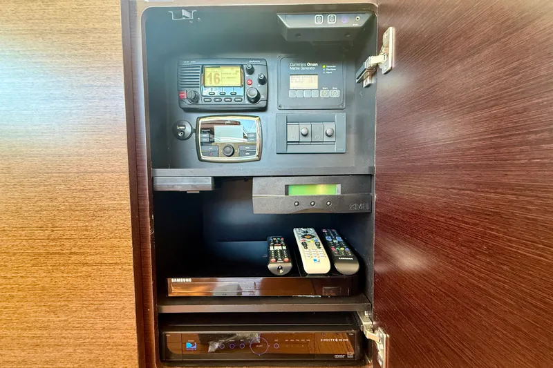 Slide: The Image of Control panel and electronics inside a 2015 Tiara Yachts 50 Coupe cabinet. - 43