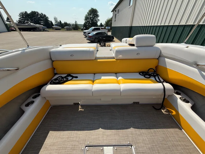 Slide: The Image of The image shows the cockpit of a 2015 Crownline 235 SS with yellow and white seating. - 22
