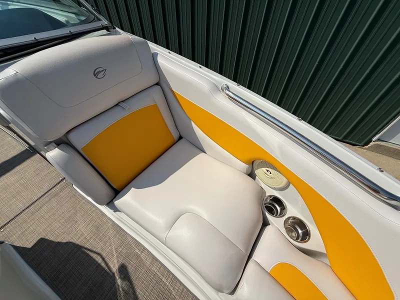 Slide: The Image of The image shows the interior of a 2015 Crownline 235 SS boat with yellow and white seating. - 13
