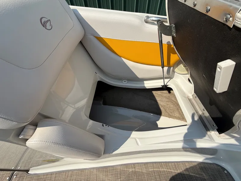 Slide: The Image of Interior view of a 2015 Crownline 235 SS boat with yellow and white seating area. - 15