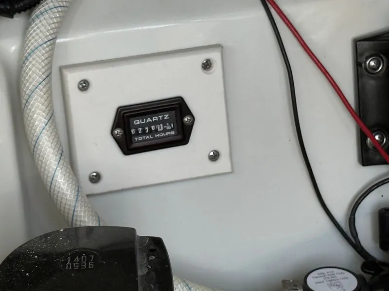 Slide: The Image of An hour meter displays 273.4 hours. Cables and hoses are visible. - 28